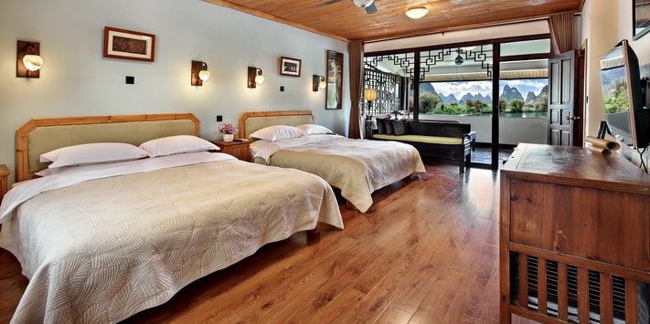 A secluded side entrance leads to the second floor of Yangshuo Mountain Retreat where a double queen bed room affords stunning views of the Yulong River. Find out why we are consistently among top Yangshuo hotels for 17 years.