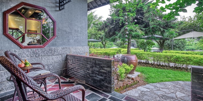 Enjoy a shaded terrace with beautiful views of the Yulong River and Yangshuo Mountain Retreat garden.